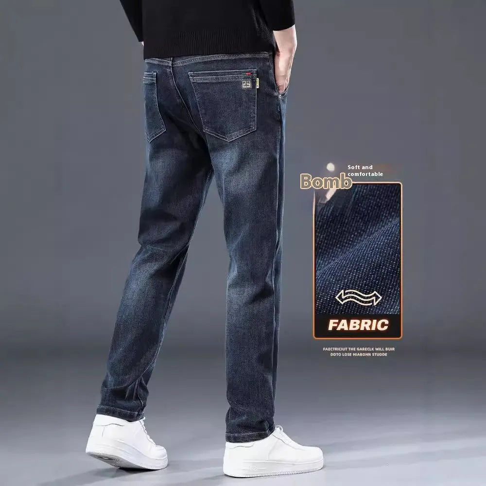 Blue grey men's slim straight casual trousers with a mid waist and zip fly on a neutral background.