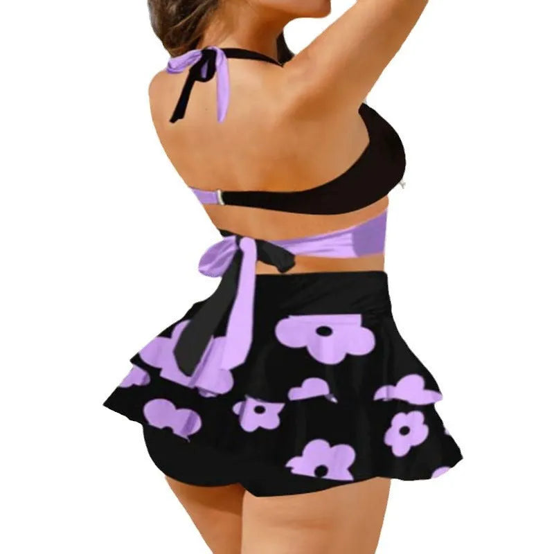 Women's purple high-waisted bikini swimsuit with skirt and lace-up back detail