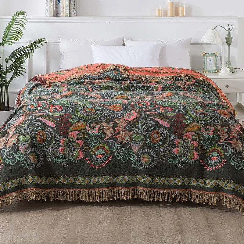 Cotton gauze towel quilt with tassels in beige flower pattern on a bed