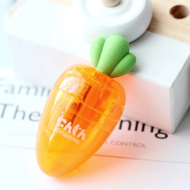 Orange carrot-shaped plastic pencil sharpener with green top, 7cm total length