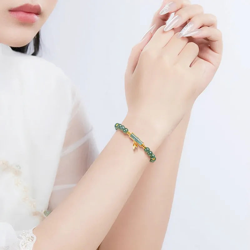 Women's high-rise bracelet with blue water round jade beads on S925 silver.