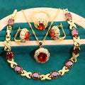 Gold-coloured jewellery set with sparkling blue cubic zirconia stones, showing necklace, earrings, ring, and bracelet.