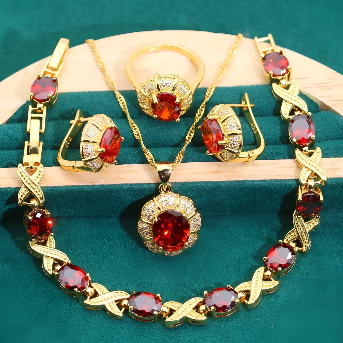 Gold-coloured jewellery set with sparkling blue cubic zirconia stones, showing necklace, earrings, ring, and bracelet.