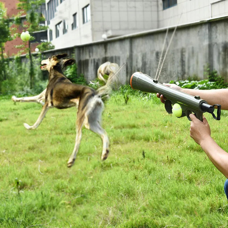 Black ABS plastic tennis ball launcher for dogs with a tennis ball ready to launch.