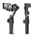 Black ABS plastic handheld smartphone video stabiliser gimbal on a table.