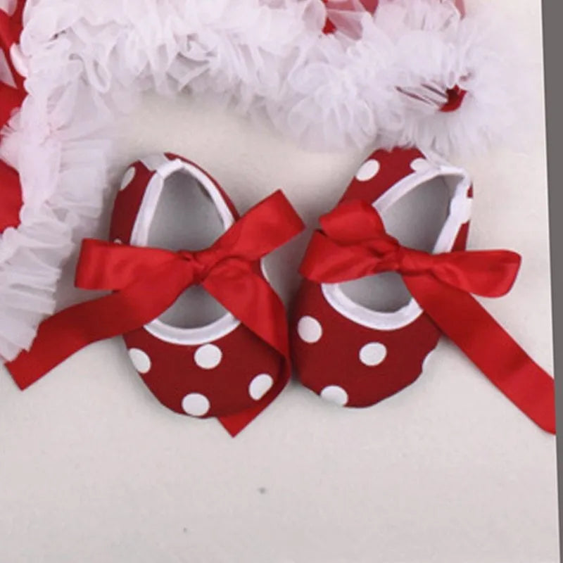 Four-piece Christmas baby clothing set featuring a cotton romper, headband, sock, and shoe for newborns.