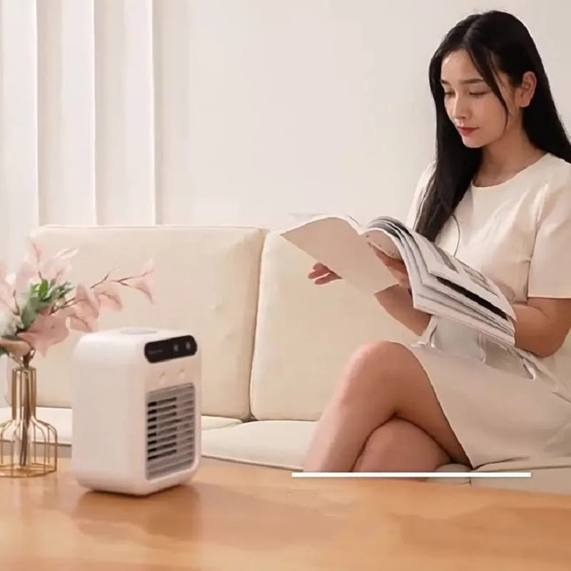 Compact ivory white portable USB air cooler with touchscreen display on a desk.