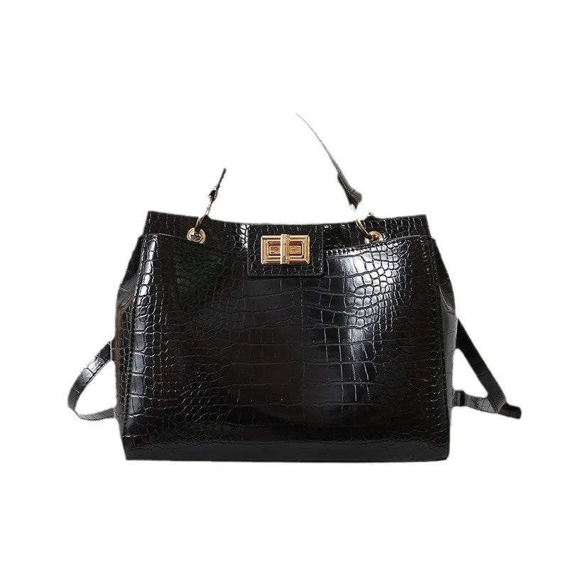 Retro western style messenger bag in black stone pattern with shoulder strap and square vertical shape