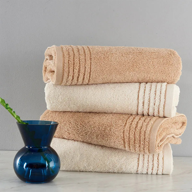 Cotton towel set in beige and brown showing face, hand, and bath towel sizes