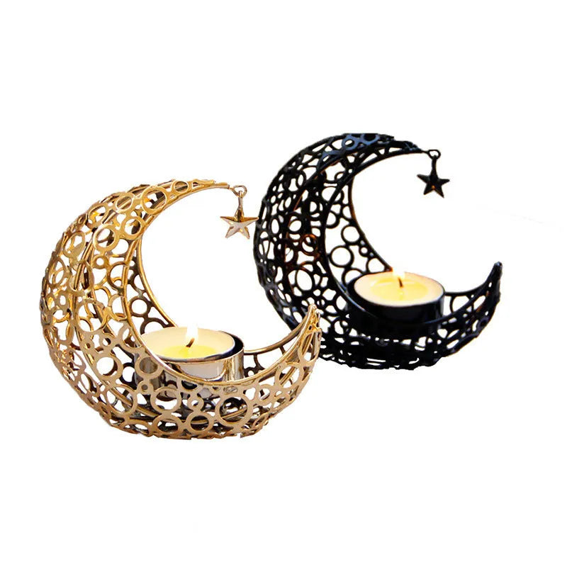 Black metal crescent moon candle holder with star cutouts on a table
