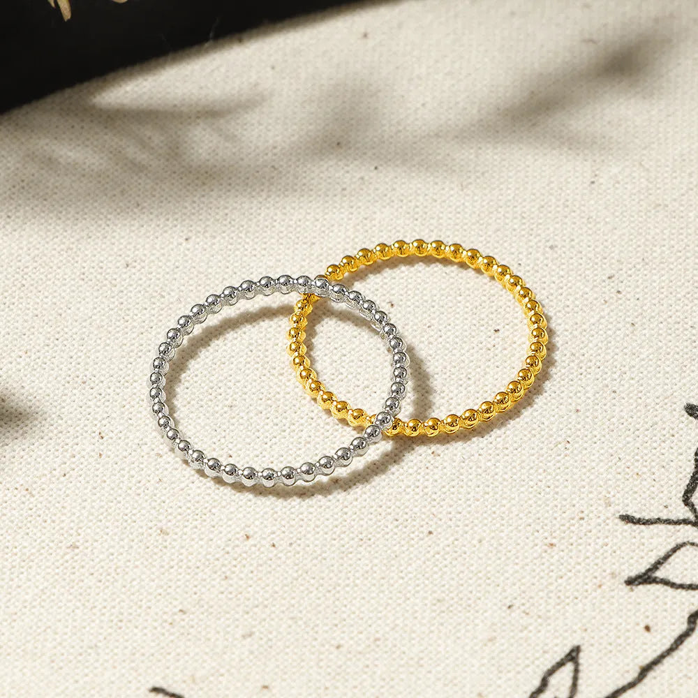 Titanium steel plain circle ring in gold finish on a neutral background