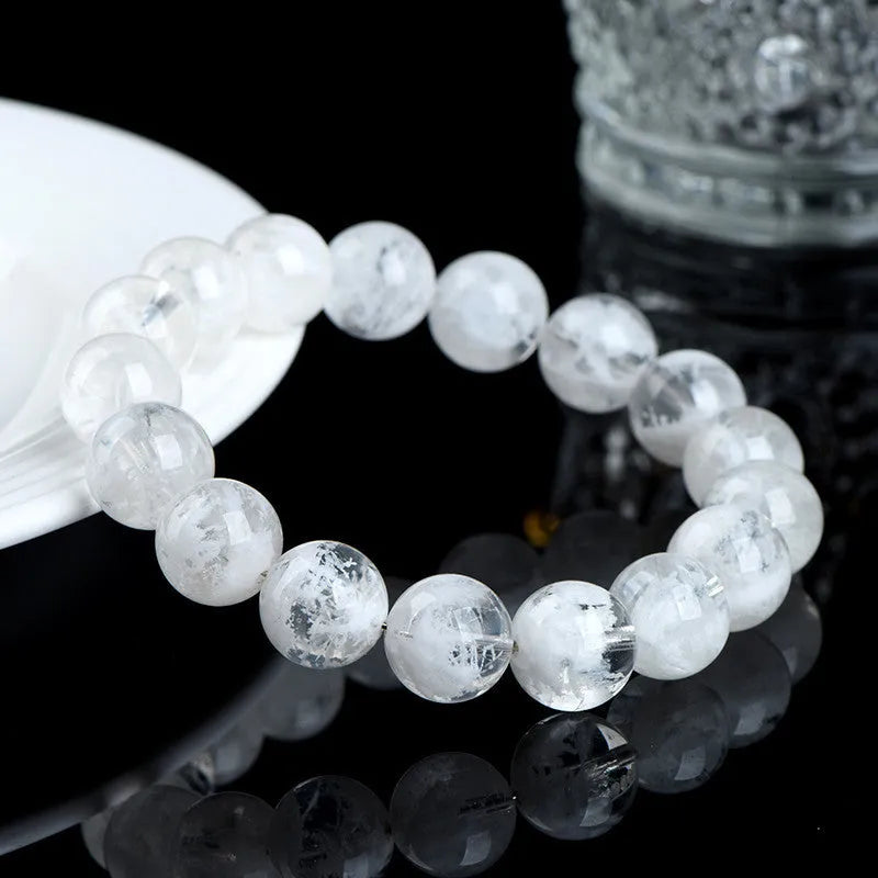 Crystal women's bracelet with natural blizzard snowflake round beads in geometric shapes showing traditional Ruyi and Xiangyun motifs