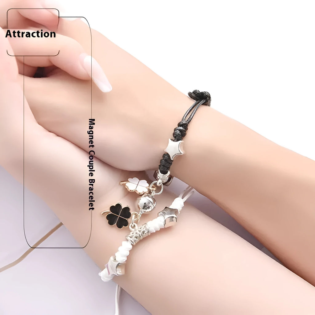 Pair of magnetic alloy bracelets with crown and heart charm designs on a wrist.