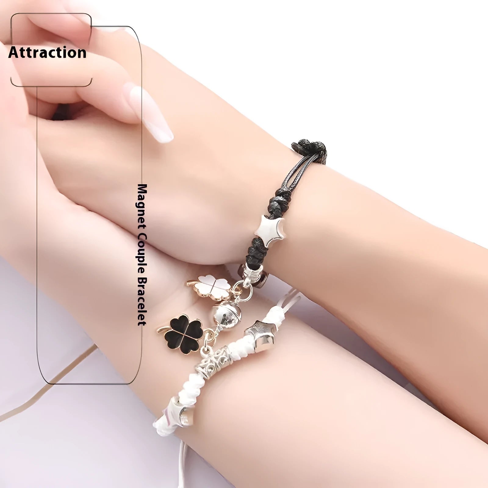 Pair of magnetic alloy bracelets with crown and heart charm designs on a wrist.