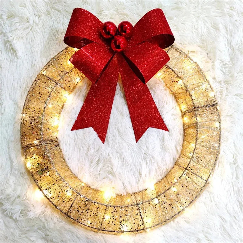 50cm gold green tinsel Christmas garland with LED lights and big bowknot on a wooden door