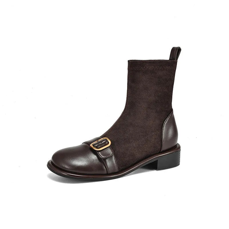 Women's black low heel Martin boot with lace-up front and decorative buckle stitching on a round toe.