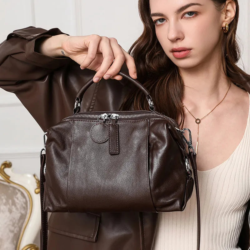 First layer cowhide leather one-shoulder messenger bag in brown with visible sewing thread and pillow shape