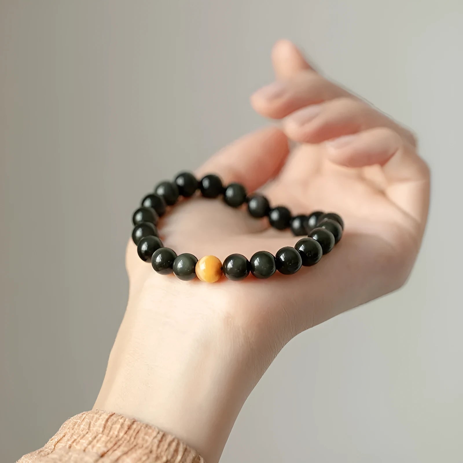 Geometric cut black obsidian stone bracelet showing 6mm, 8mm, and 10mm size beads.