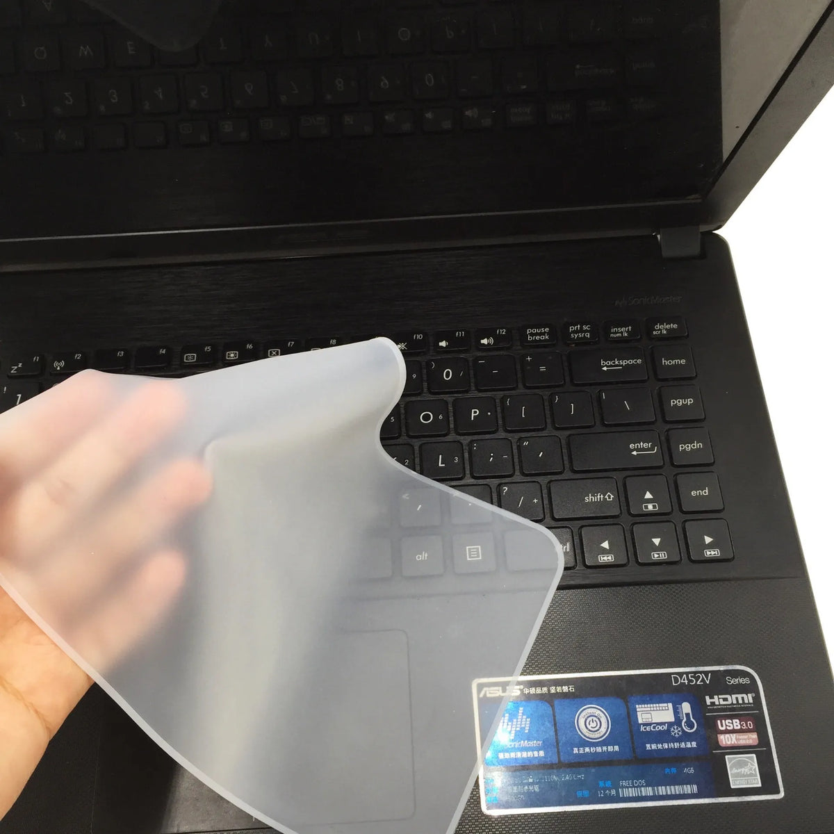 Transparent silicone keyboard dust film for 15 inch laptop showing close fit over keys
