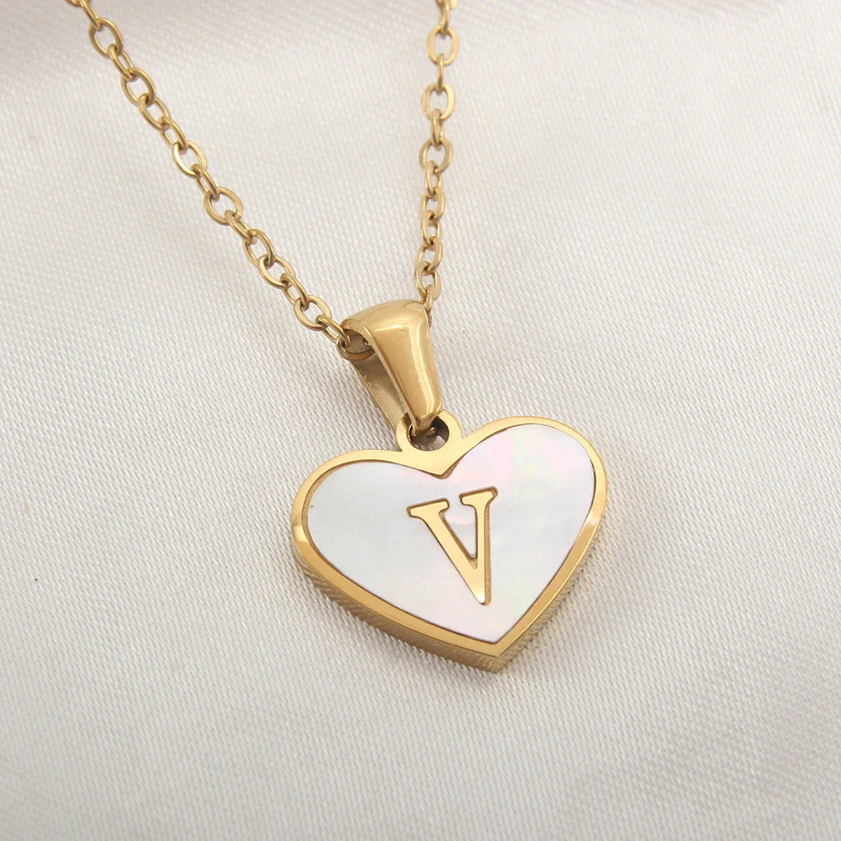 A personalized heart-shaped necklace with a 26-letter charm, crafted from high-quality stainless steel and gold plating.