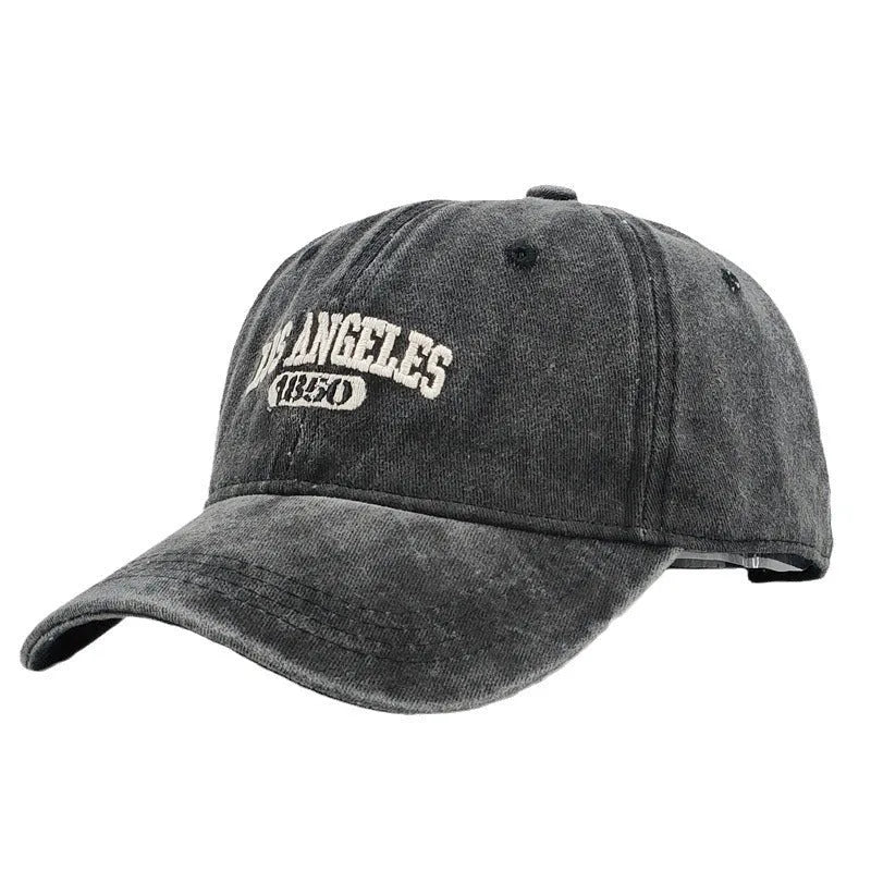 Retro distressed acrylic cap with embroidered letters, shown in beige colour with adjustable strap.