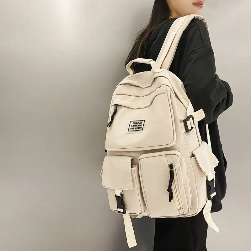 Black or white nylon student backpack with computer compartment measuring 31x12x41cm