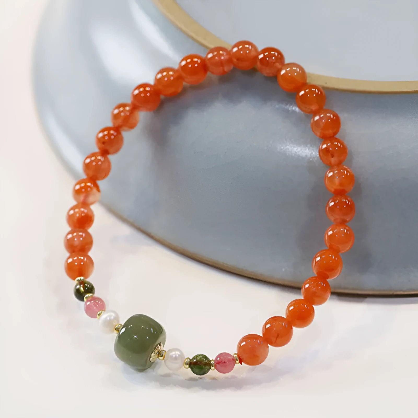 Close-up of a women's bracelet with round cherry red South Red Agate beads in a retro ethnic style.