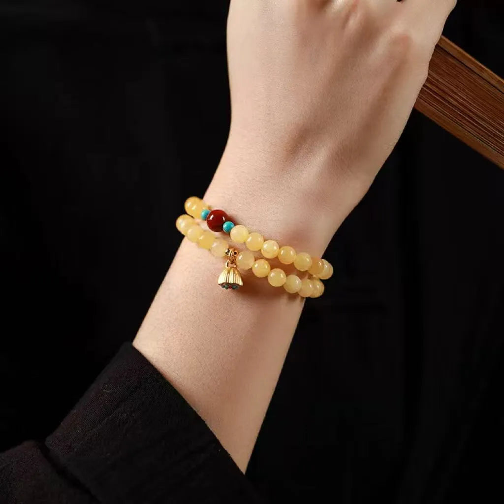 Yellow jade coloured topaz bracelet with double ring design and lotus seedpod beads
