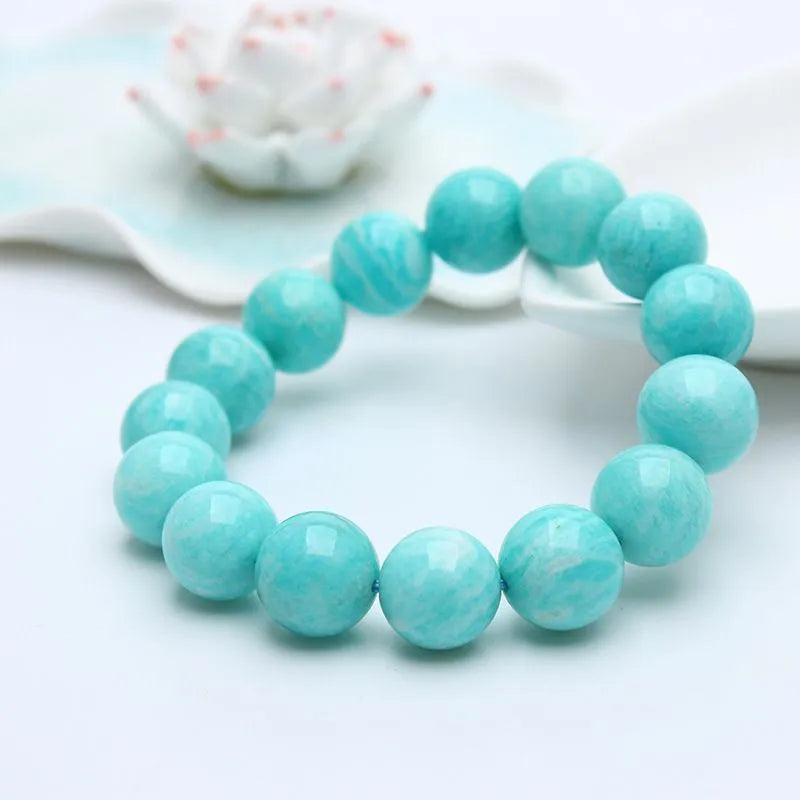 Natural blue-green amazonite gemstone beaded bracelet with stainless steel clasp on a wrist.