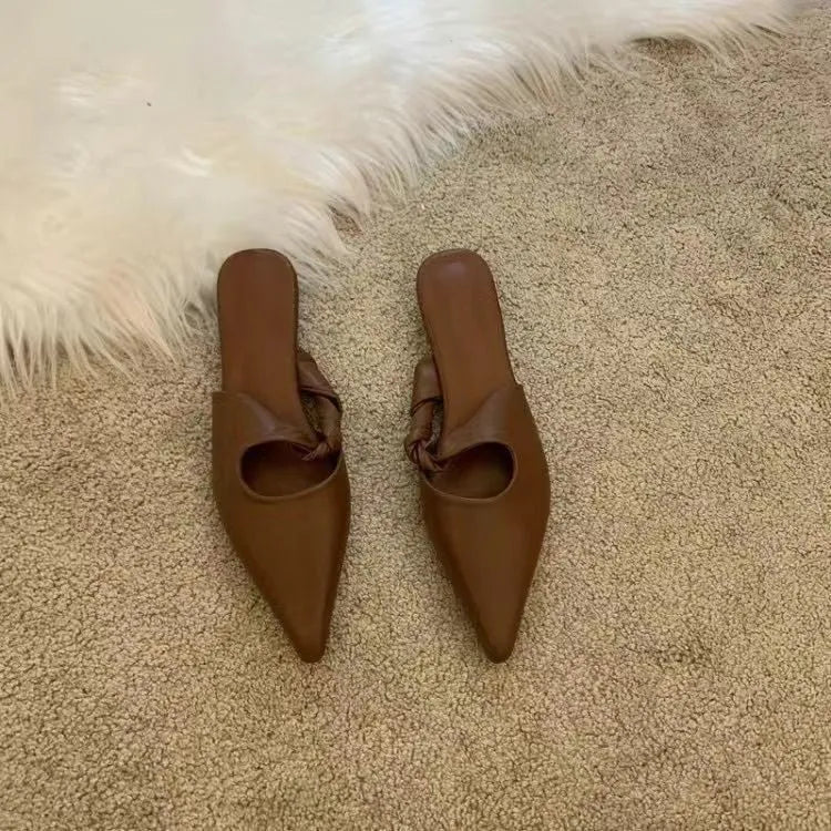 Women's soft leather slippers in dark brown with a semi-toe box design and rubber sole.