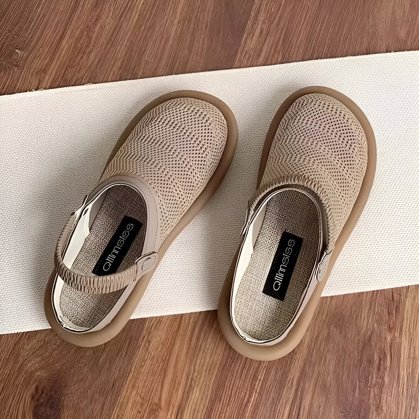 Beige linen slip-on shoes with mesh lining and a light rubber sole on a neutral background.