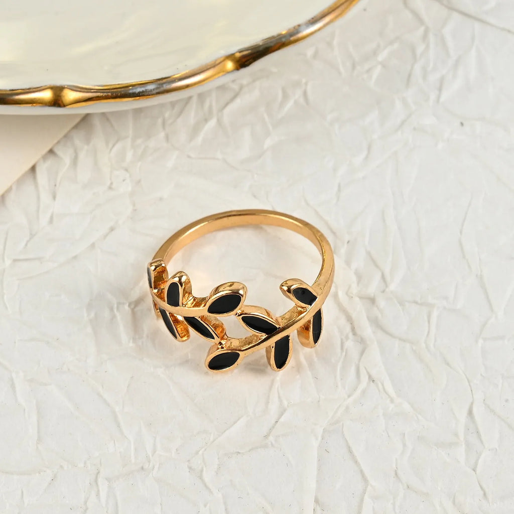 Gold geometric leaf and floral acrylic ring for women on a white background.