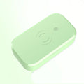 White UV disinfection box for nail tools with wireless phone charging function on a table.