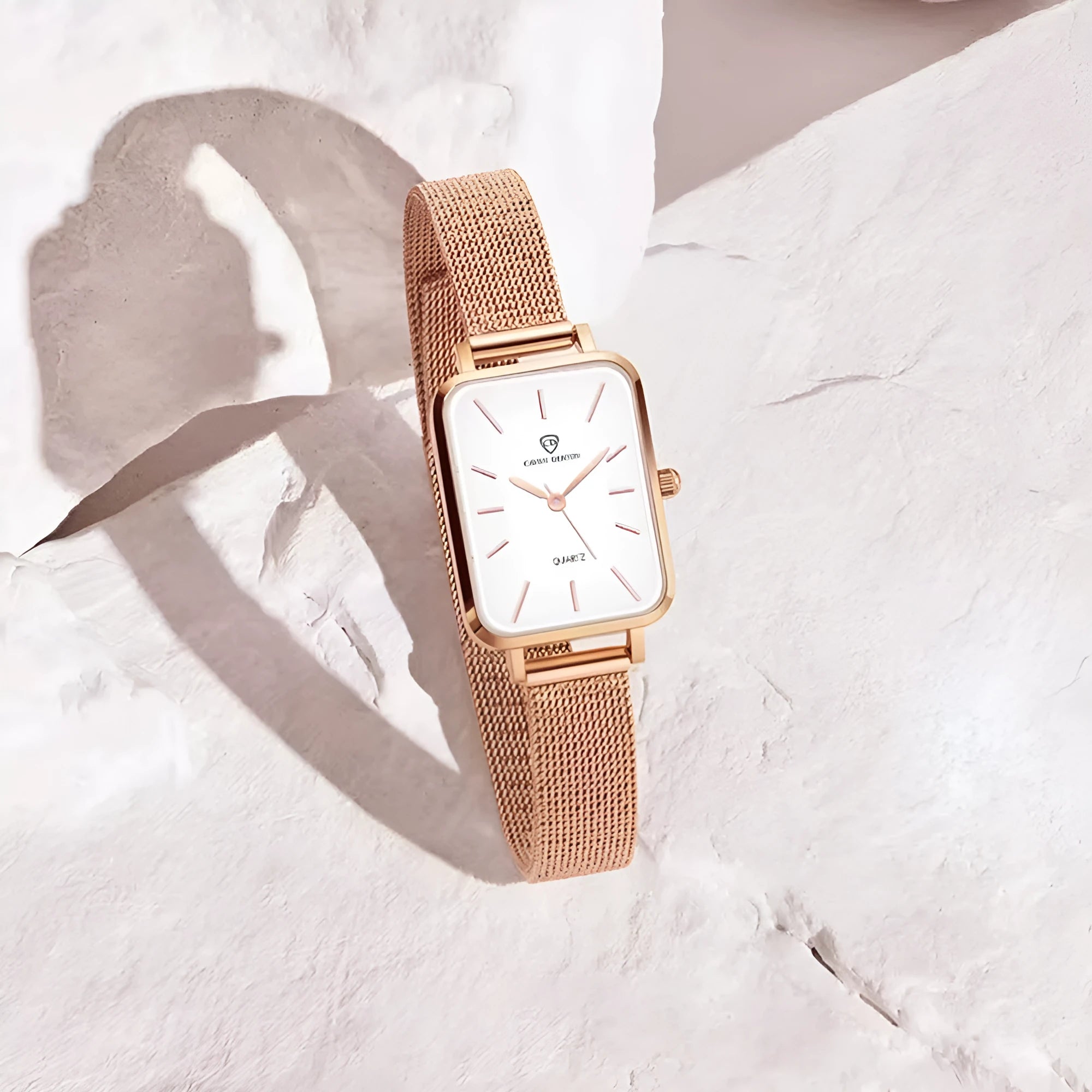 Women's rose gold or silver waterproof watch with woven steel strap and analogue dial.
