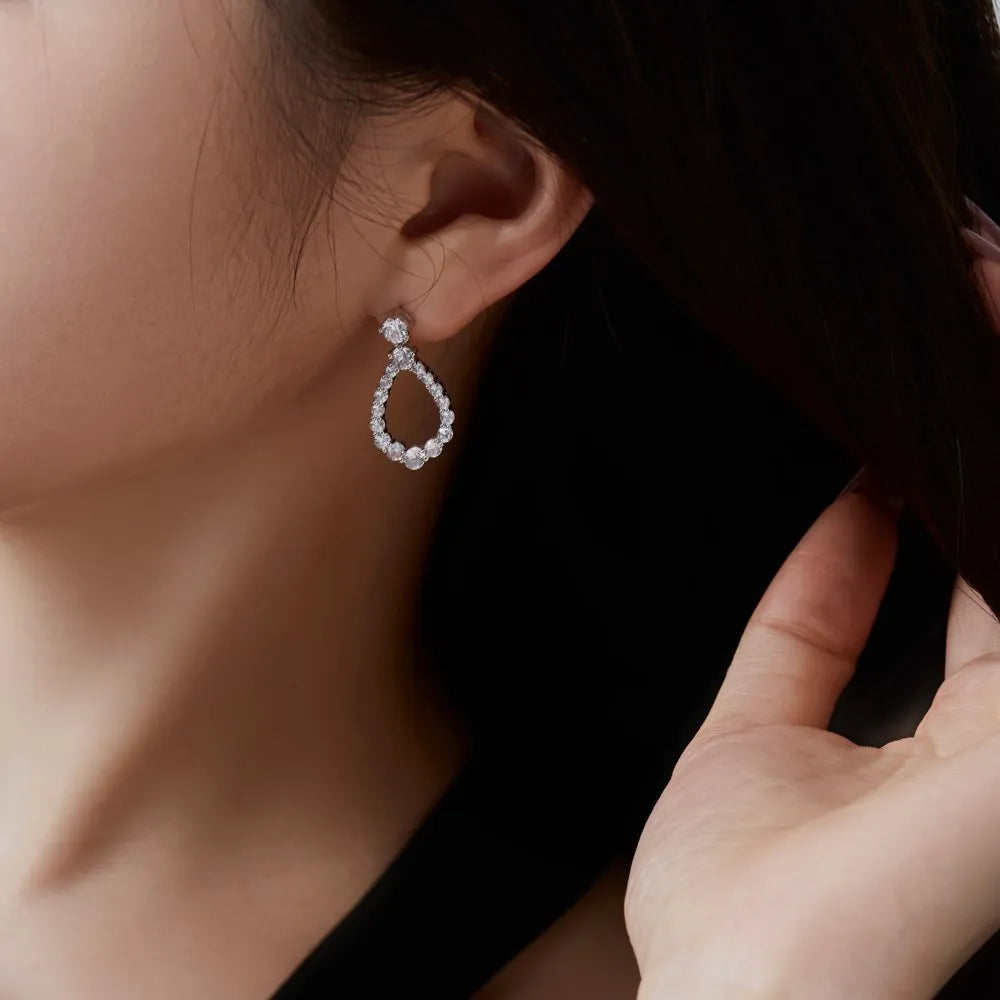 925 silver hollow zircon water drop earrings for women, platinum electroplate finish, 15 x 28.5mm teardrop shape on black background
