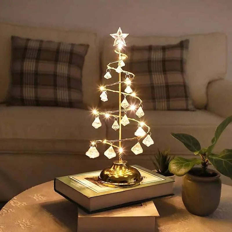 Gold crystal Christmas tree LED light with battery-powered warm glow on a shelf