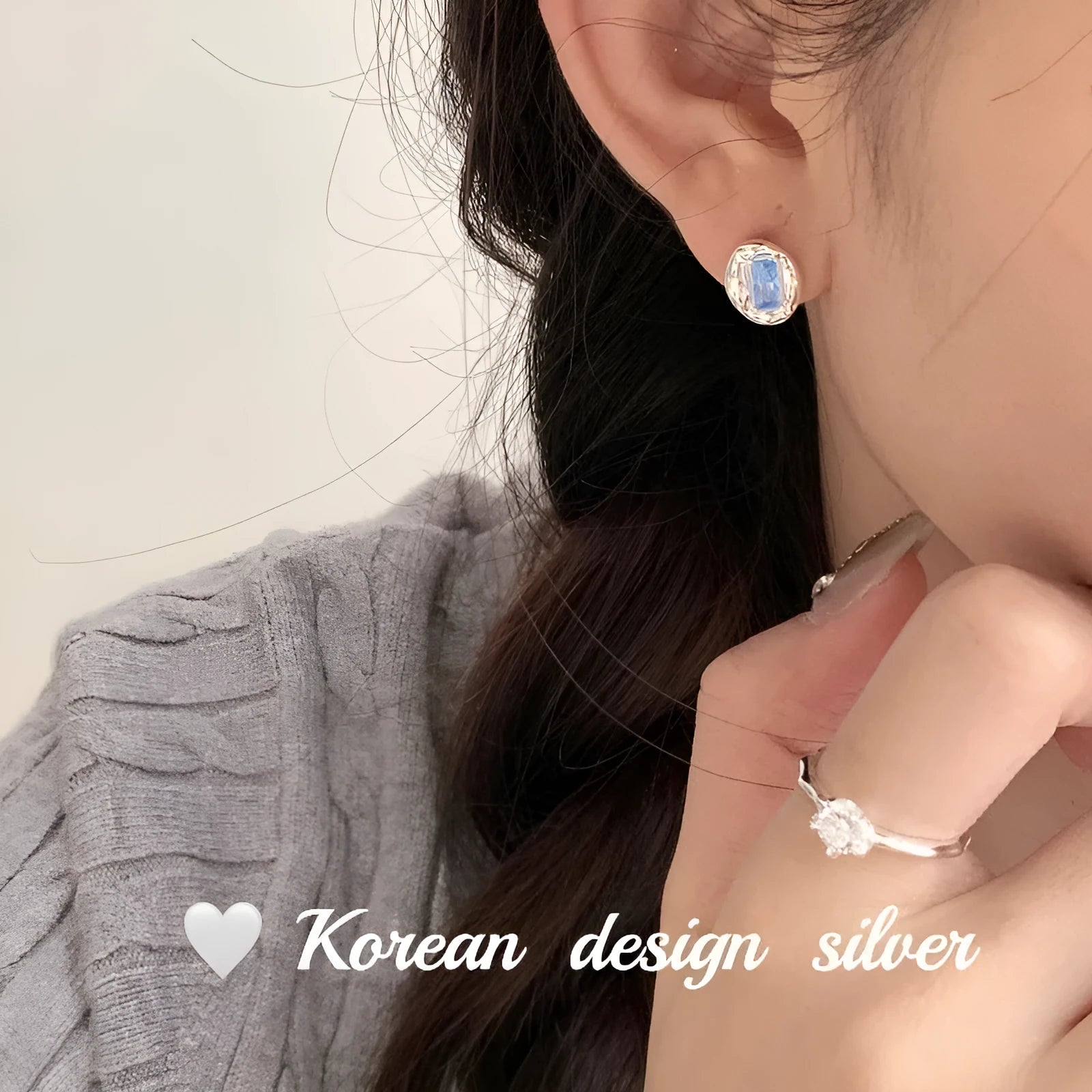 S925 sterling silver earrings with heart-wrapped oval design and blue diamond detail