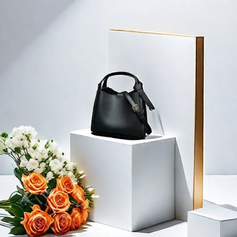Genuine cowhide leather women's crossbody shoulder bag in bucket shape with interior zipper pockets.