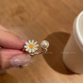 Women's copper opening ring with a sweet twin daisy design and pearl accent on a white background.