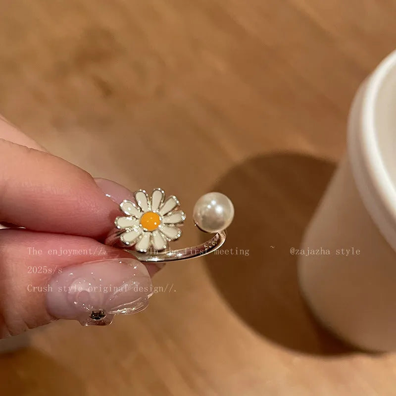Women's copper opening ring with a sweet twin daisy design and pearl accent on a white background.