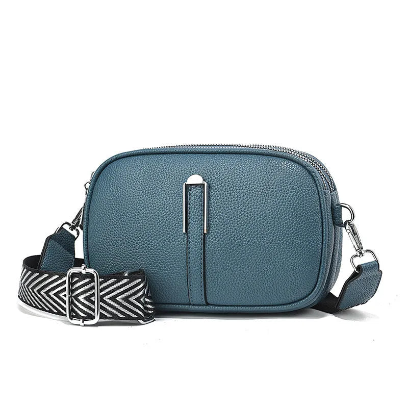 Soft oval PU leather crossbody handbag with stone pattern and internal organiser compartments.