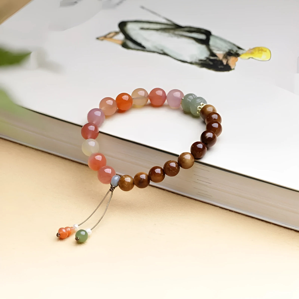 Handmade agate bracelet with 8mm diamond-shaped beads showing natural persimmon colour elements