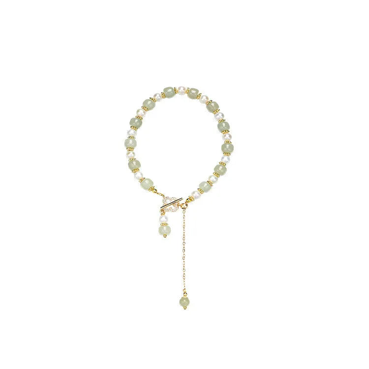 Women's bracelet with a round Hetian jade bead, pearl pendant, and gold-colour alloy clasp.