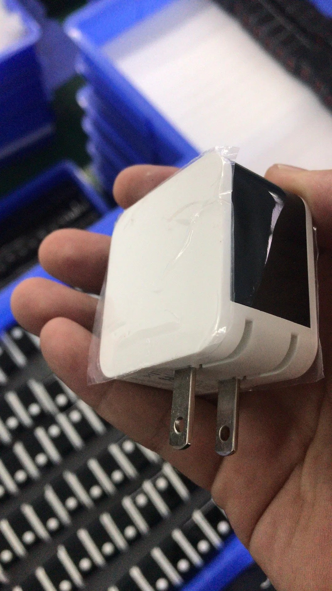 5V2.4A dual USB travel charger with digital display in black, white, or red, showing US and EU plug options.