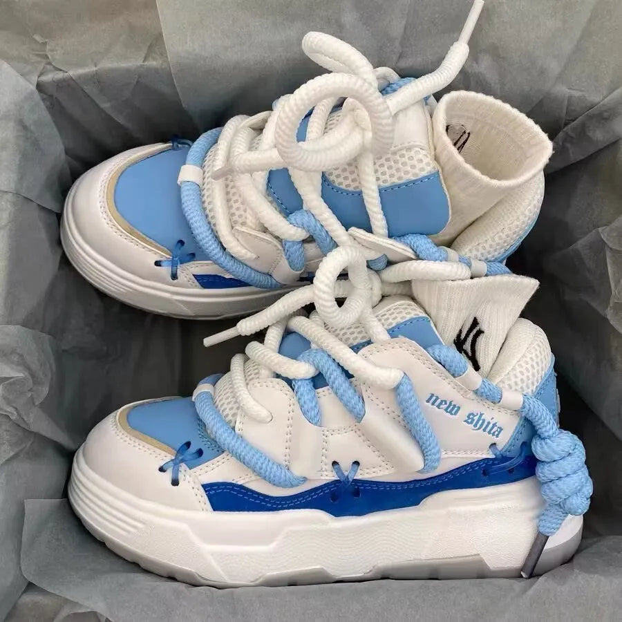 Women's grey clunky sneakers with thick rubber sole and round toe, shown with blue and black colour options.