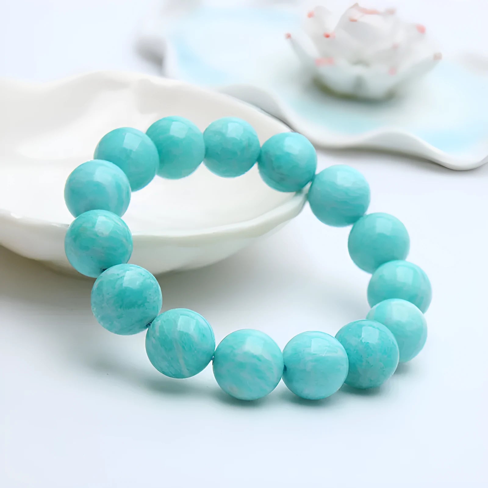Natural blue-green amazonite gemstone beaded bracelet with stainless steel clasp on a wrist.