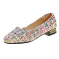 Women's black and white low-top canvas shoes with pointed toe and flat rubber soles