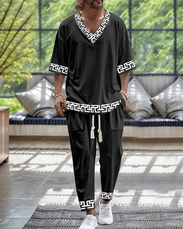 Women's cropped sleeve V-neck trousers suit in thin polyester fabric showing jacket and matching trousers