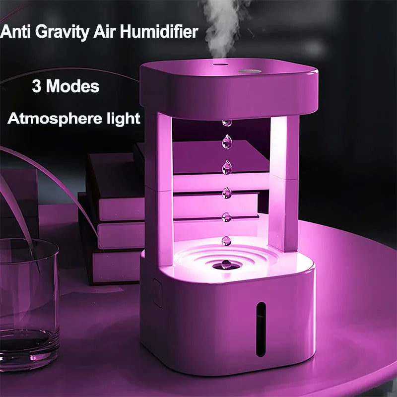Anti-gravity water drop humidifier with coloured lights on a desk, showing water droplets appearing to float.