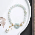 Jade bracelet with emerald peace buckle charm and pearl pendant in geometric national style design